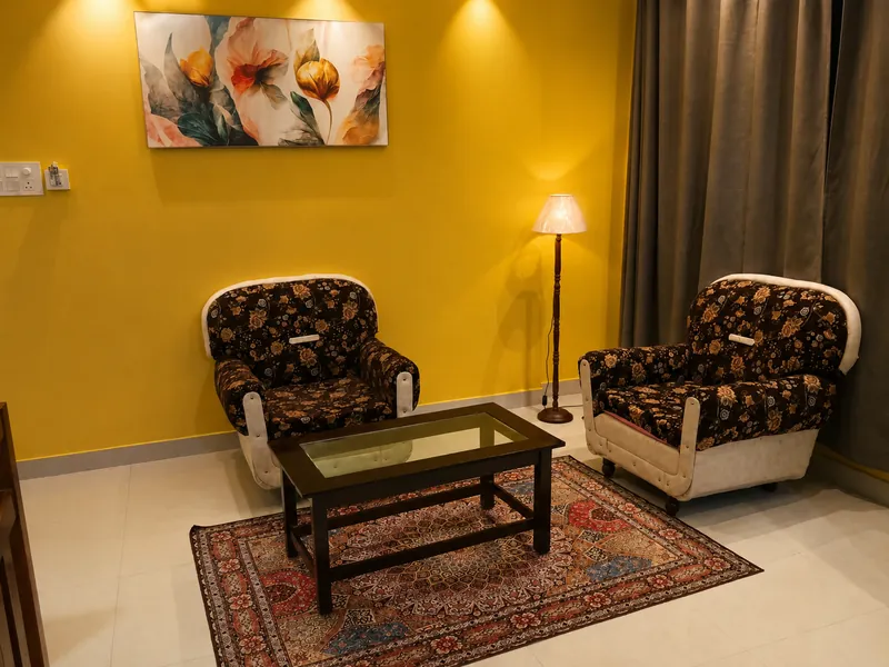 Nahor Suite living room with armchairs, coffee table and rug